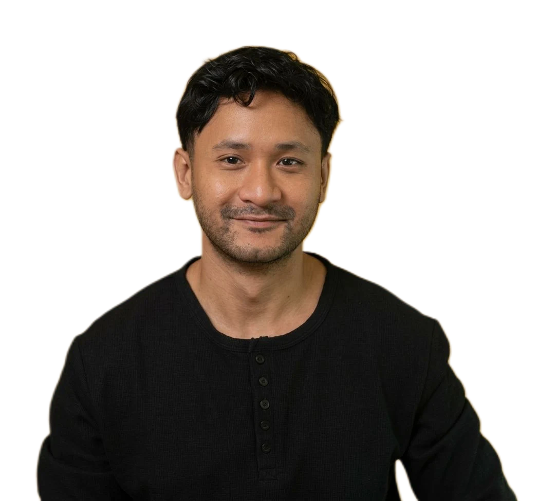 Adam Helmi in a black henley, smiling